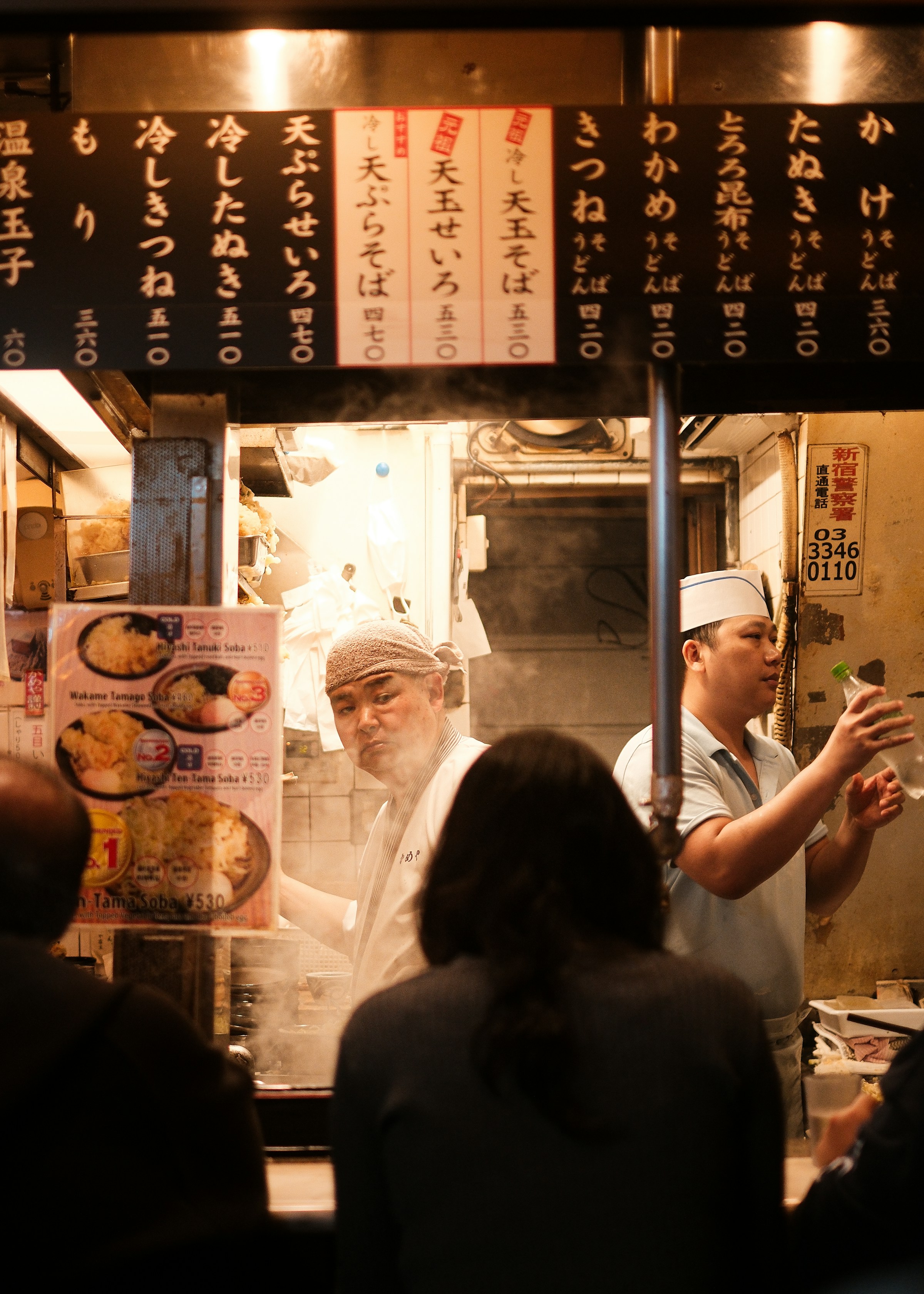 Noodle shop with chefs and diners in Shinjuku, Tokyo